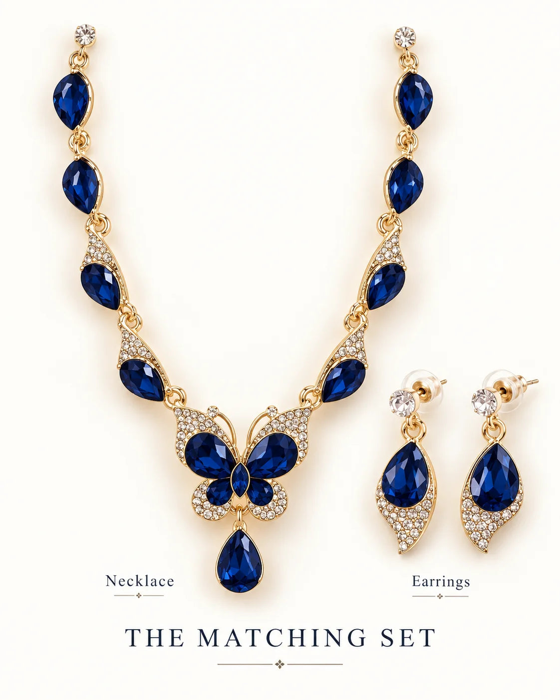 The matching set: navy blue butterfly necklace and teardrop earrings on white