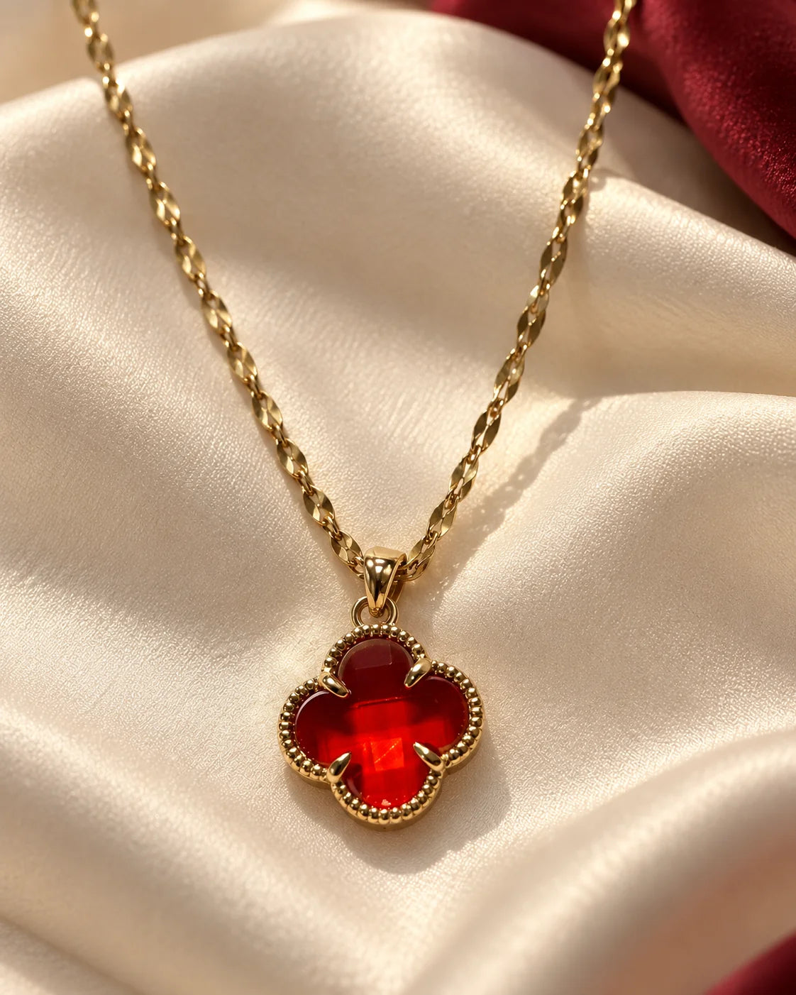 Fortuna cherry red clover necklace on ivory satin