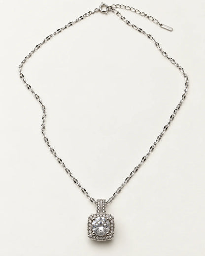 Full length of the Celeste silver cushion halo necklace laid flat with its extender chain