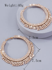 Rose gold triple-row hoop earrings with clear rhinestones, displayed on a light gray background with dimension markings of 7.3cm and 7.