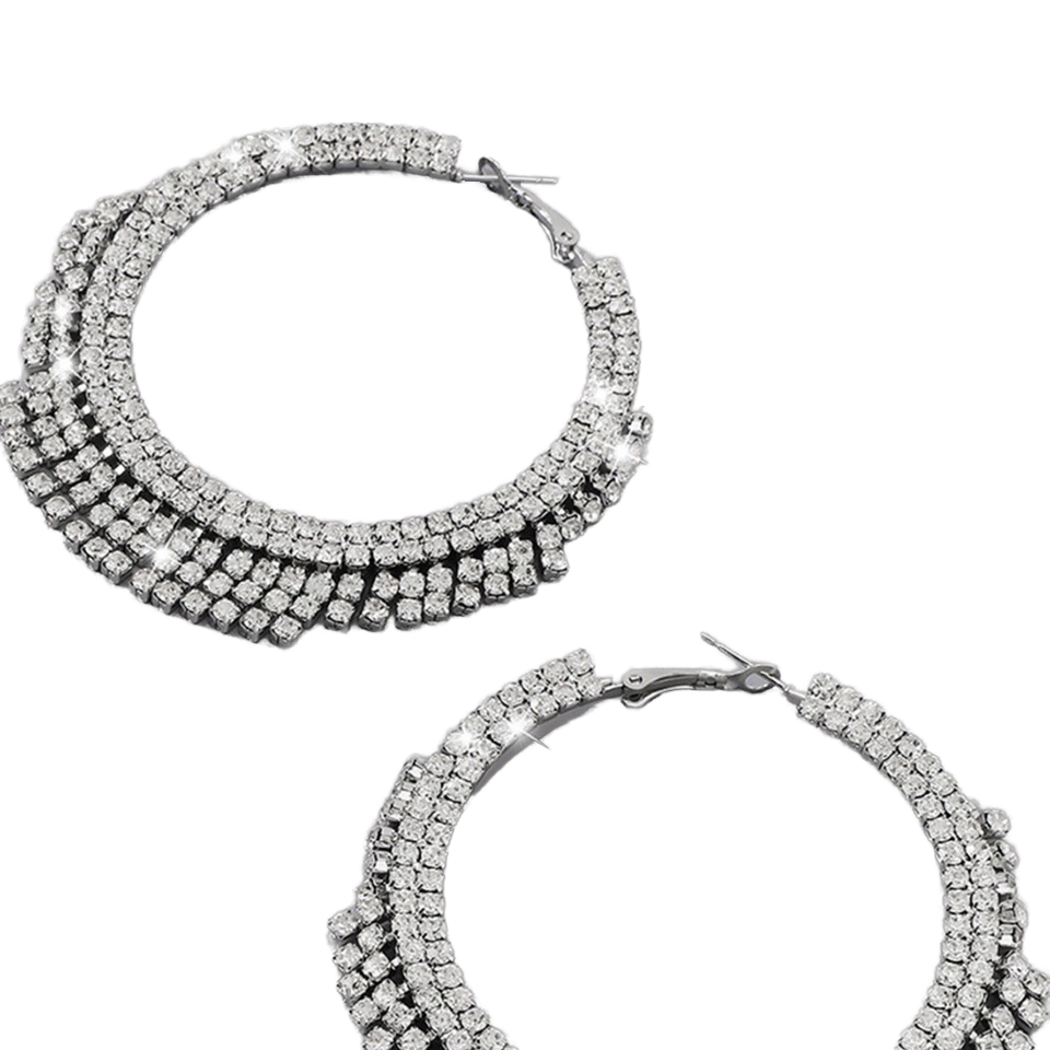 A pair of silver-tone hoop earrings covered in multiple rows of clear cubic zirconia stones, shown on a plain white background.