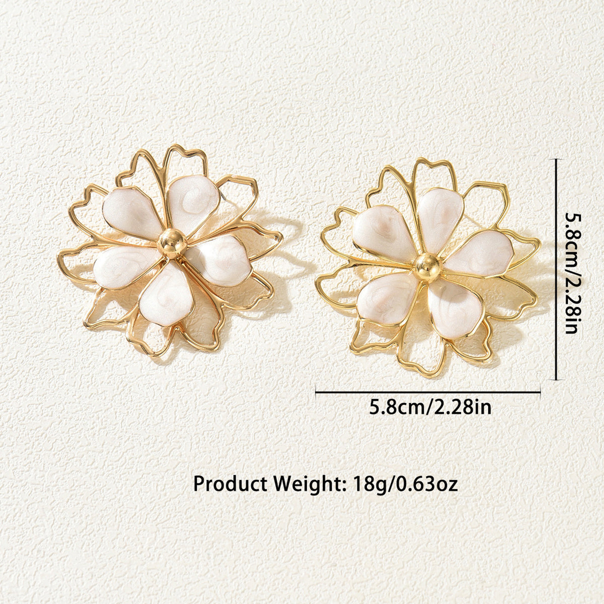 A pair of gold-tone flower-shaped stud earrings with white mother-of-pearl petals, shown on a textured off-white background with dimension labels indicating 5.8cm width and height, and product weight text below.