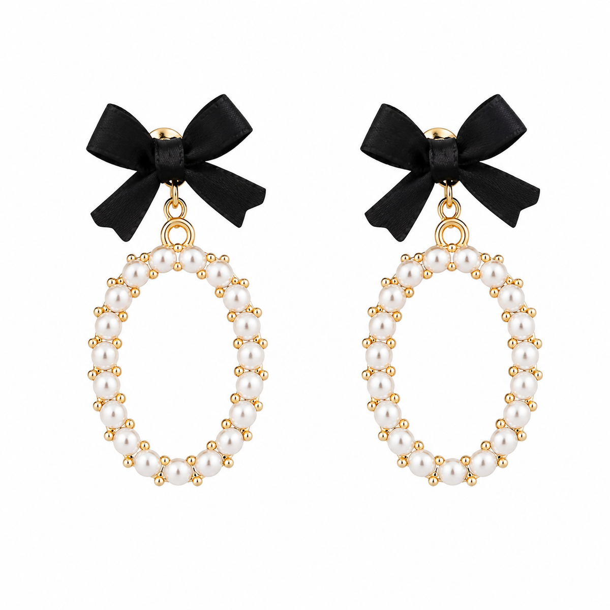 A pair of dangling earrings featuring black satin bows at the top and oval hoops framed with white faux pearls and gold-tone metal beads, shown on a plain white background.