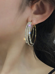 A close-up of a Woman model's ear wearing Celestia silver crystal drop earrings