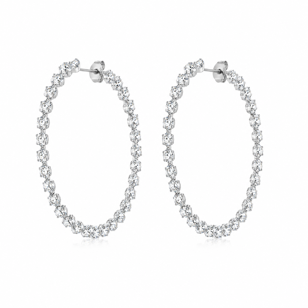 A pair of silver-tone hoop earrings adorned with a continuous row of clear round-cut stones, presented on a clean white background.
