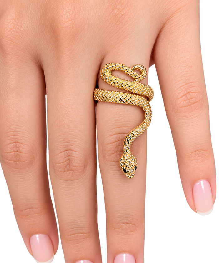 A gold snake ring with detailed scales wrapped around a finger, shown on a hand with light pink manicured nails against a white background.