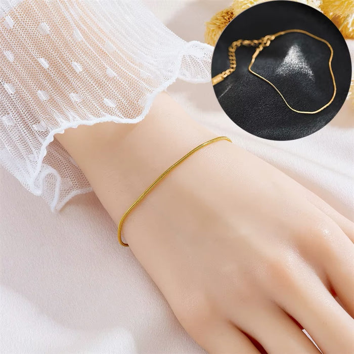 Gold bracelet on a wrist with a close-up inset on a black background