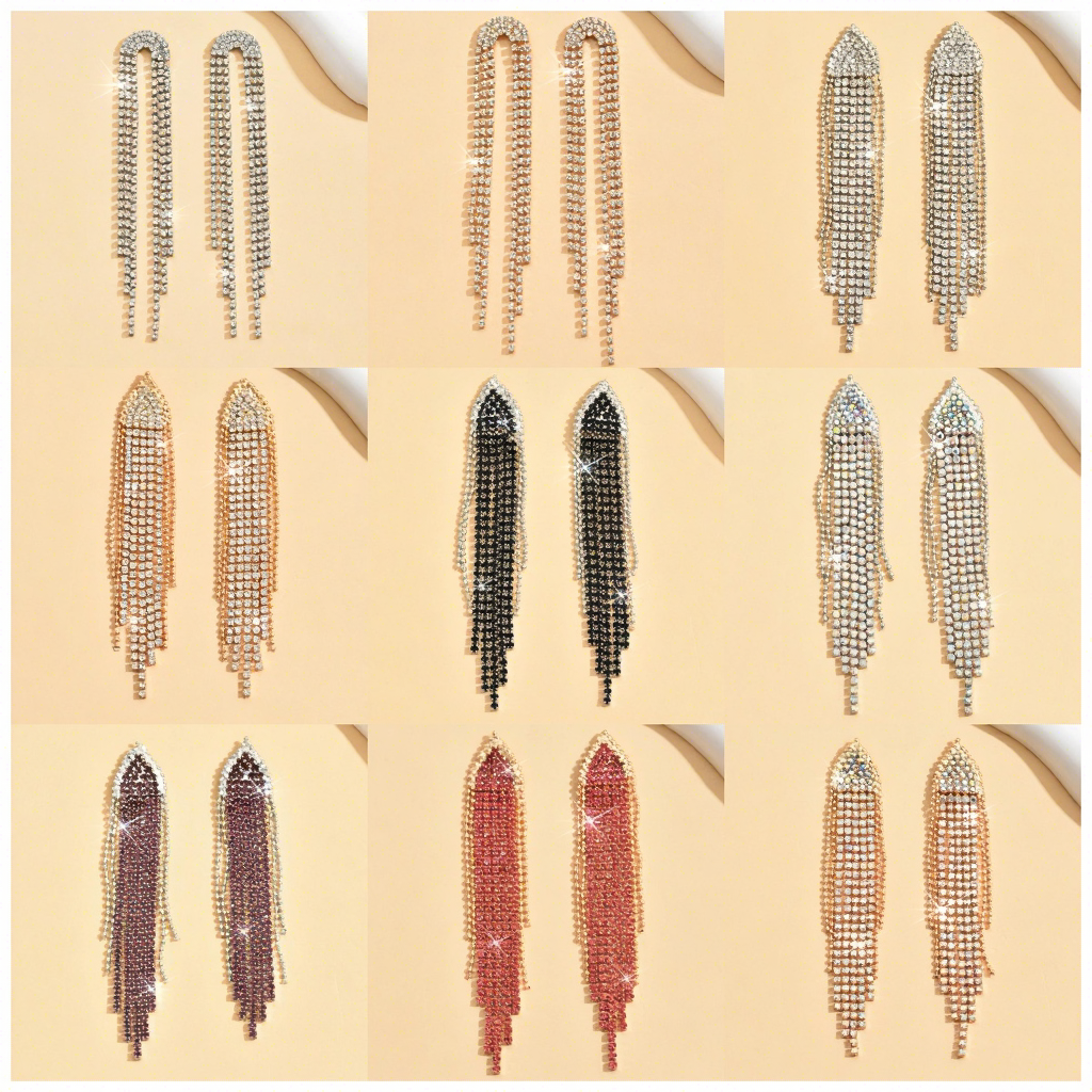A 3x3 grid showing nine pairs of long dangling rhinestone fringe earrings in different colors, including silver, gold, black, rose gold, and mauve, displayed on a light beige background.